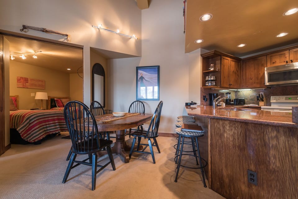Gather around your rustic dining table or perch at the breakfast bar while savoring morning coffee in this warm, open-concept space.
