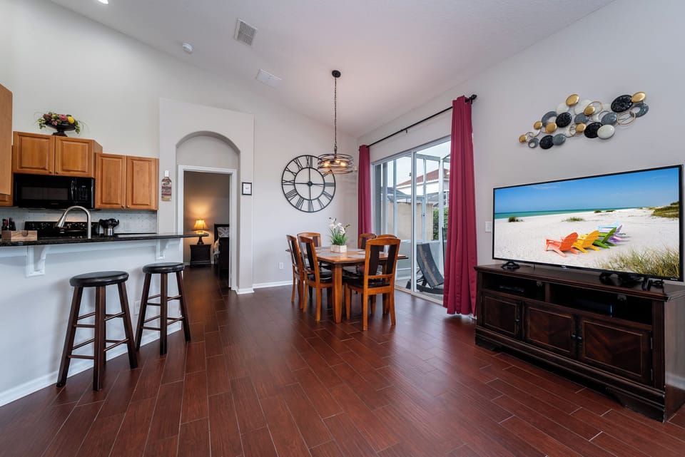 Living room showing TV and dining room.