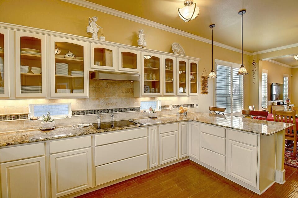 Cook memorable meals in your elegant kitchen featuring granite countertops, pendant lighting, and premium appliances—perfect for preparing breakfast before exploring.