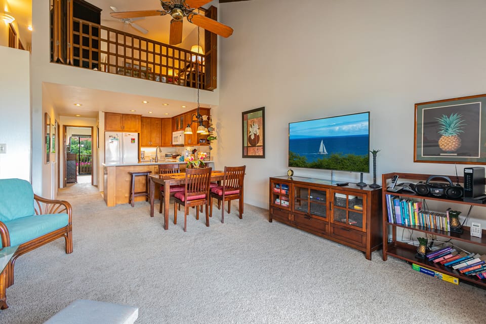 Relax in your open-concept living space with soaring ceilings, ocean views, a fully equipped kitchen, and entertainment ready for your tropical getaway.