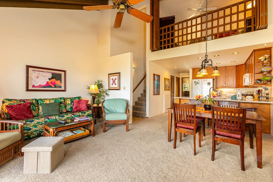 Relax in your bright, open living space with cozy seating, tropical accents, and a lofted retreat, all just steps from your full kitchen—perfectly designed for comfort and togetherness.