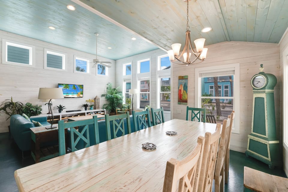 Gather around this spacious dining table where your group can share meals and create memories together in this bright, coastal-inspired space.
