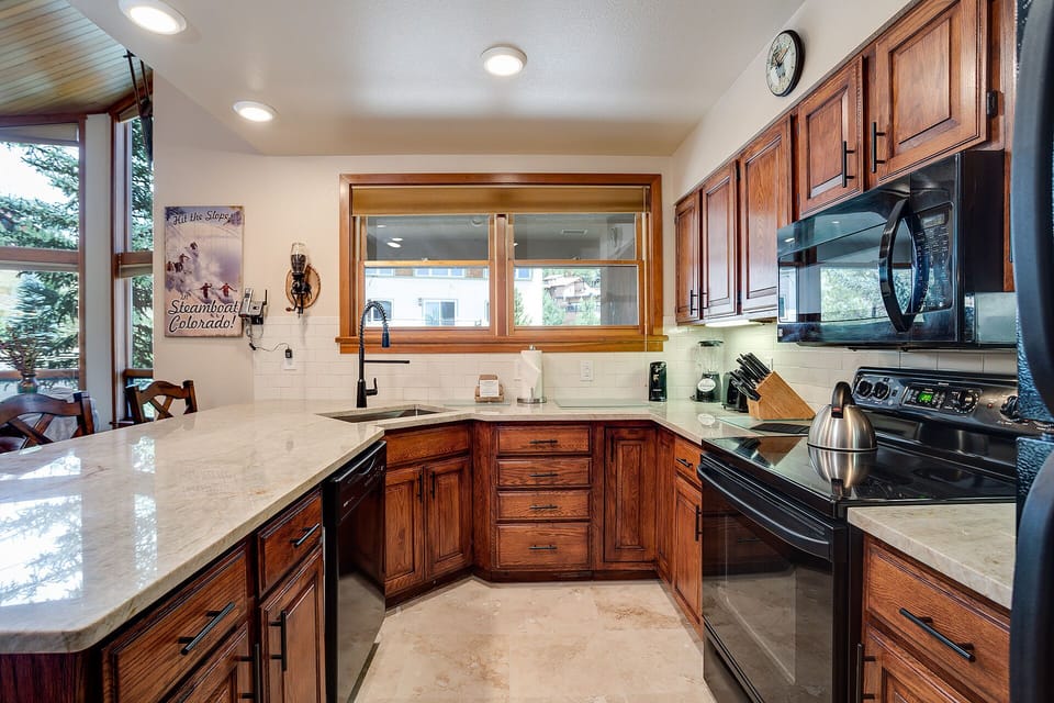 Your culinary dreams come alive in this gorgeous kitchen, where rich wood cabinets and gleaming countertops invite you to create memorable meals.