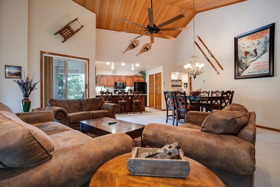 Sink into plush sofas beneath soaring wood ceilings where your group can gather around the cozy coffee table before preparing meals together.