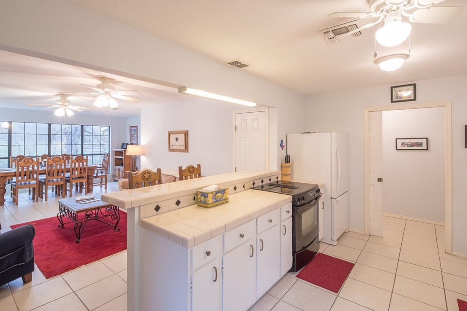 Kitchen with bar seating for 2 opens to cozy sitting area