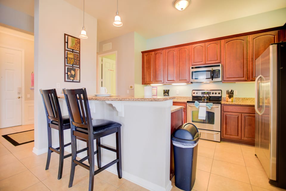 - Glorious kitchen of the condo in Orlando - Fully equipped with all kitchen accessories and stainless steel appliances - Availability of comfy high chairs at the breakfast bar - Elegant lighting  - Plenty of storage space