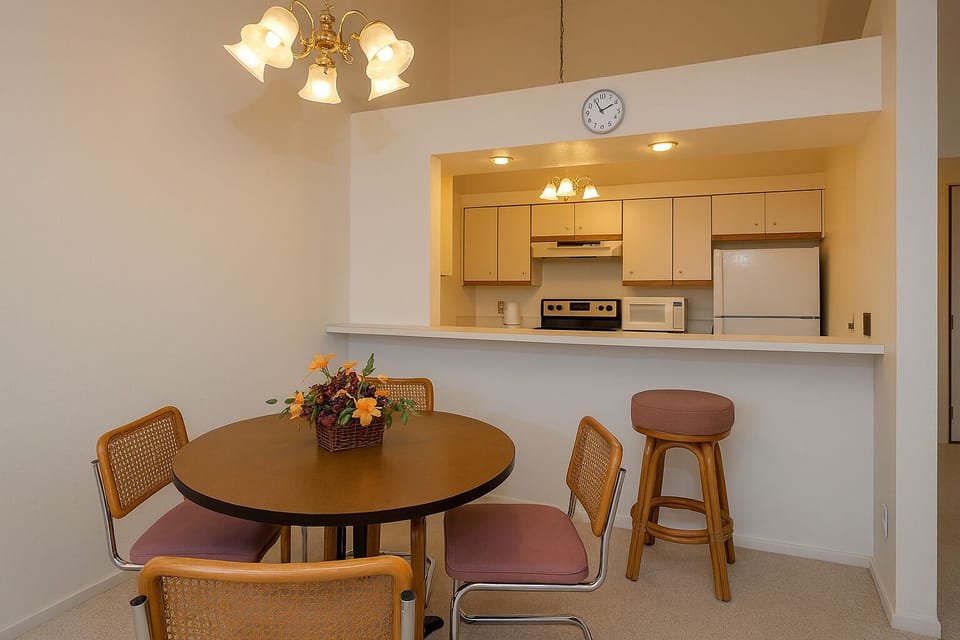 Your open dining area flows seamlessly into a well-equipped kitchen, perfect for preparing and enjoying meals together. The cozy table invites relaxed breakfasts and evening conversations in this bright, welcoming space.