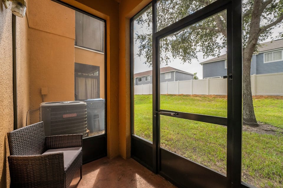 Screened porch with seating.
