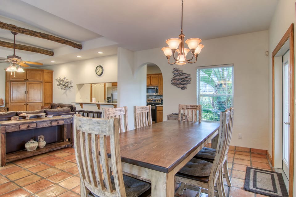 Gather around your spacious dining table where warm wood tones and rustic charm create the perfect setting for memorable meals together.