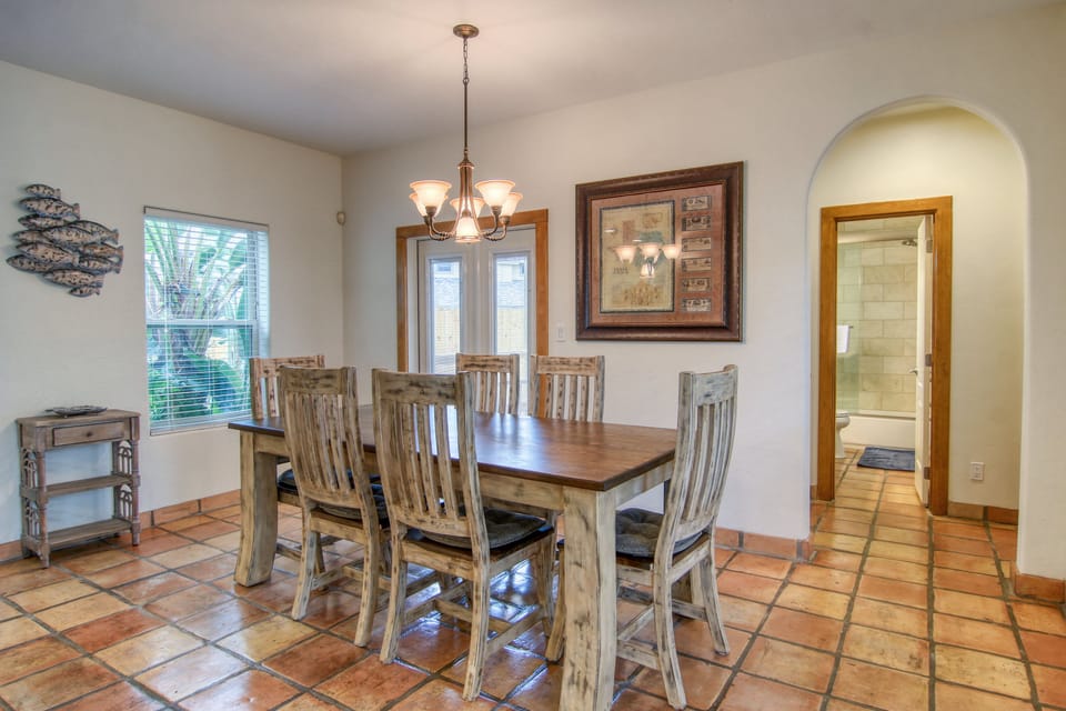 Gather around your rustic dining table for memorable meals with loved ones in this warm, inviting space filled with natural light.