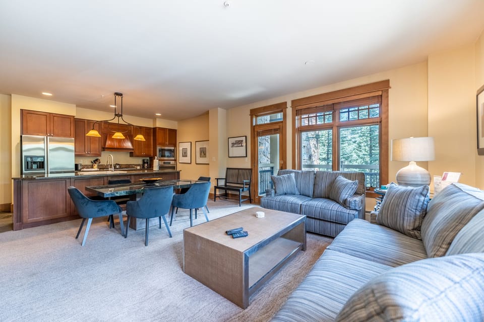 Relax in your spacious open-plan retreat where a gourmet kitchen flows seamlessly into a comfortable living area with forest views.