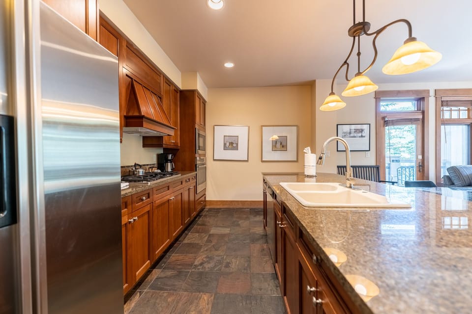 Your gourmet kitchen features rich cherry cabinets, granite countertops, and stainless steel appliances, perfect for creating memorable meals together.
