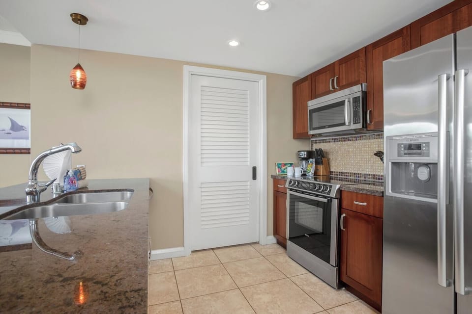 Fully equipped kitchen with stainless appliances and sleek granite counters.