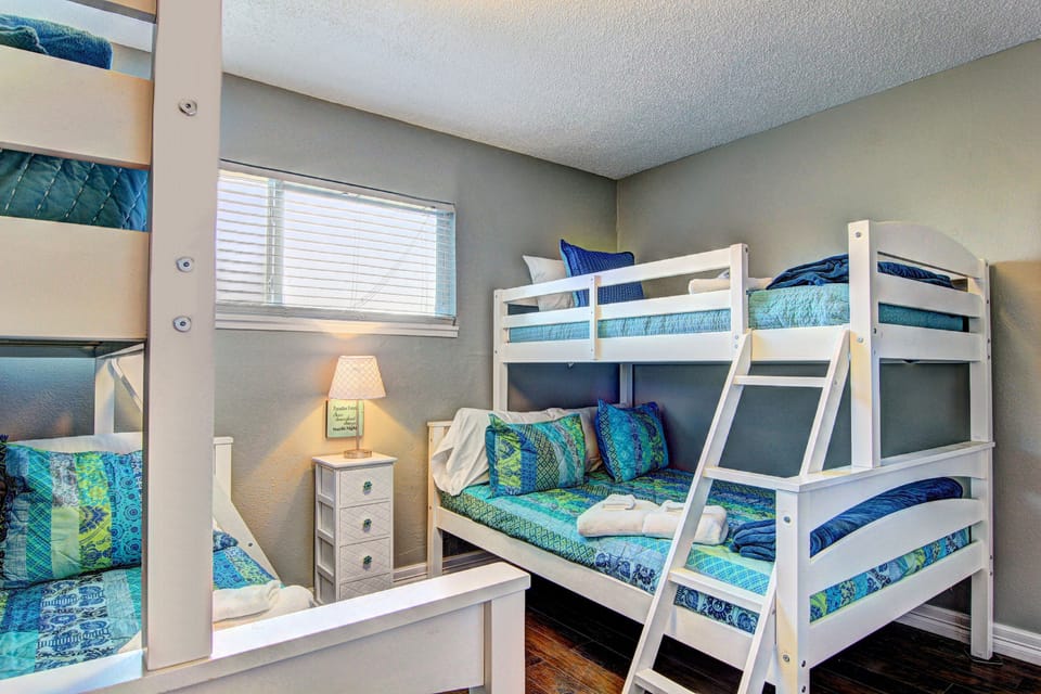 Your kids will love this cozy bunk room with ocean-themed bedding and warm lighting, perfect for bedtime stories and sleepy giggles.