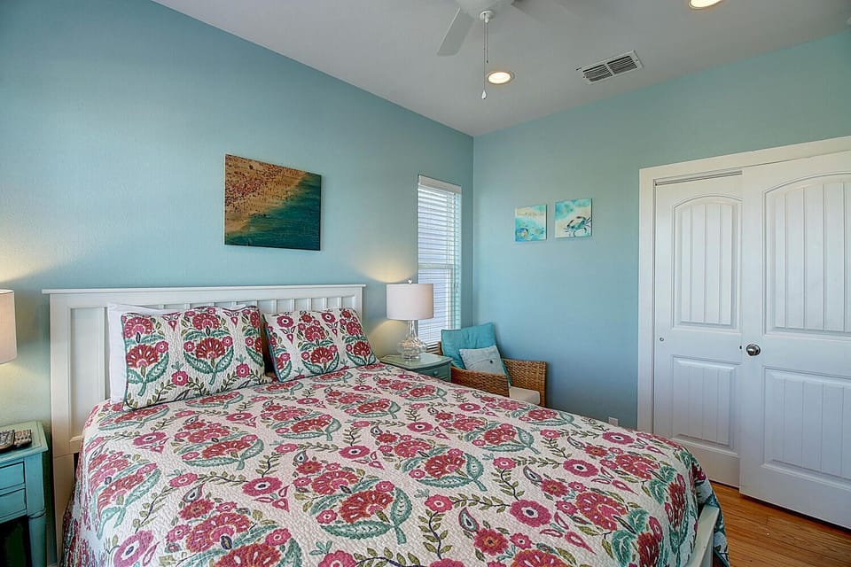 Drift into peaceful sleep in your serene bedroom with soothing coastal colors, comfortable bedding, and charming seaside artwork.
