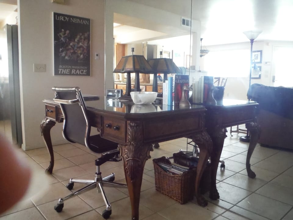 Another view of desk with kitchen in back.