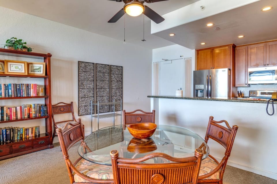  Tropical wood tones and breezy fans set the stage for cozy meals, beachy chats, and carefree island-day planning  