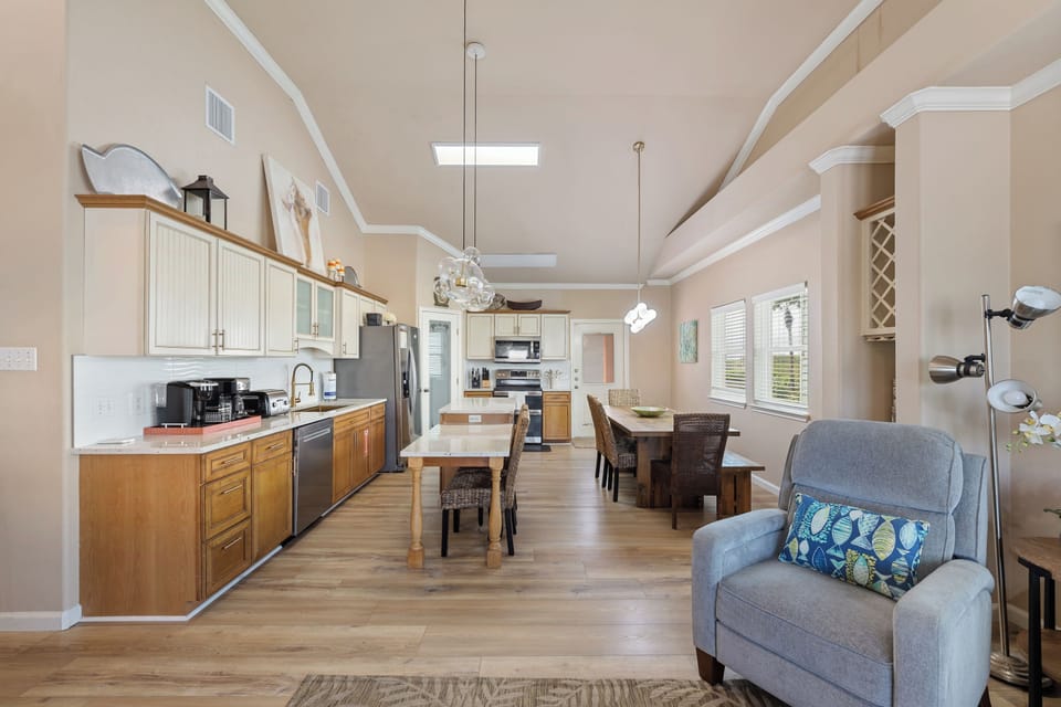 The open floor plan flows effortlessly from the living room to the kitchen and dining area, offering plenty of space for family and friends.
