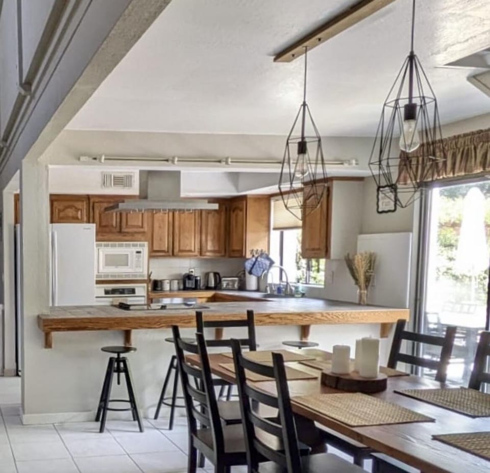 The bright open kitchen has bar seating for4 and a farm table ready for up to 6