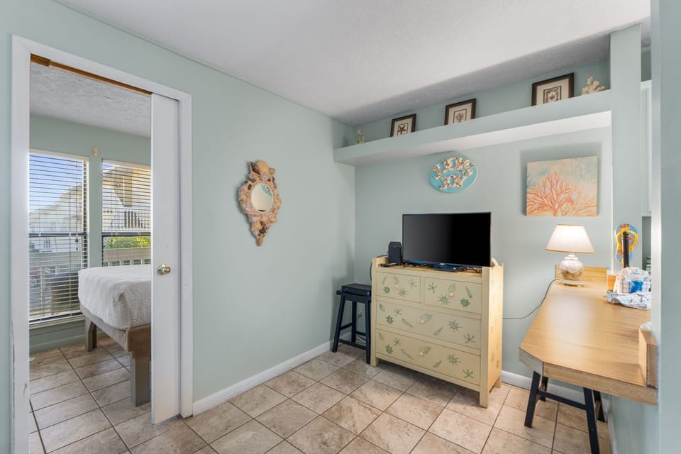 Your coastal-themed retreat features a charming workspace and entertainment nook, complete with beach-inspired décor and thoughtful storage that keeps your getaway organized and serene.