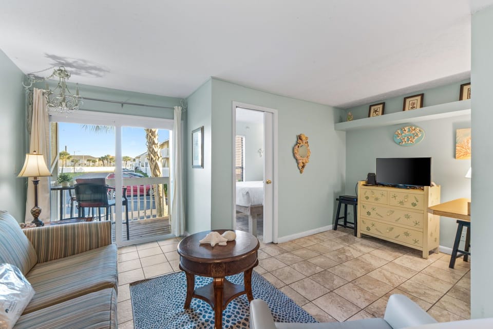 Relax in your coastal retreat with calming aqua walls, charming nautical decor, and a private balcony where you can sip morning coffee while palm trees sway outside.