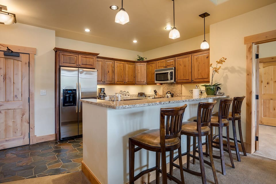Gather around the spacious granite island where your group can cook, chat, and create memories together in this beautifully appointed kitchen.