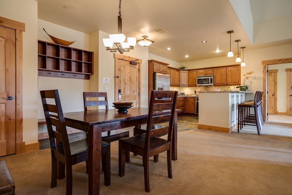 Gather around your elegant dining table while the full kitchen beckons with granite counters and modern appliances for memorable meals together.