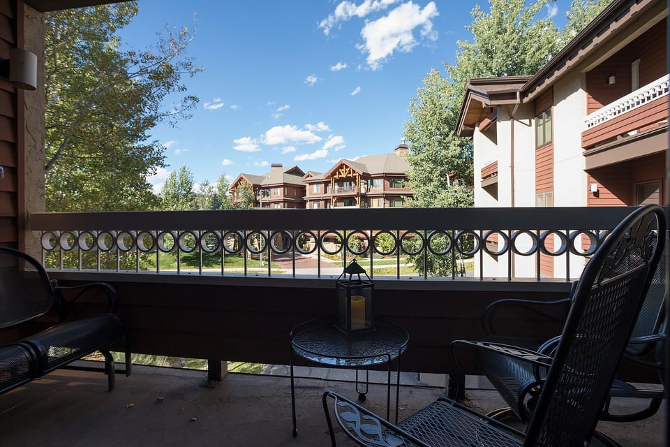Step onto your private balcony and settle into comfortable seating while taking in views of the charming resort buildings and lush greenery.