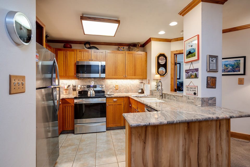 Cook up your vacation memories in this welcoming kitchen with granite counters and stainless steel appliances.