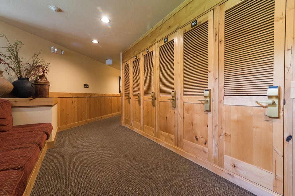 Secure your belongings in these spacious wooden lockers while you relax in comfort on the cozy seating nearby.