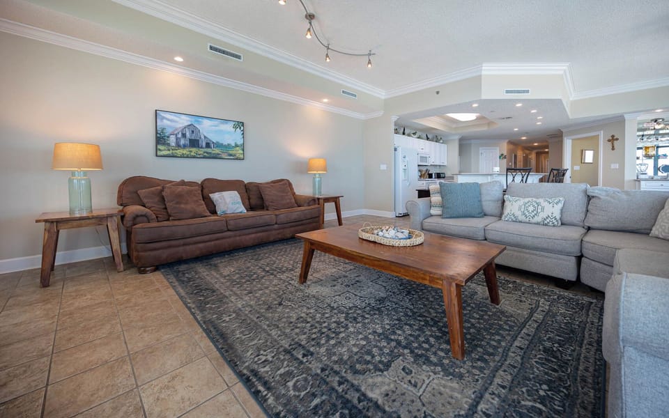 Gather in this welcoming living space and enjoy stunning panoramic beach views through the windows