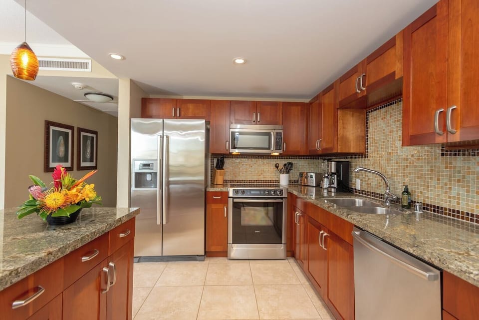 Prepare meals with ease in this elegant kitchen featuring granite counters, stainless appliances, and charm