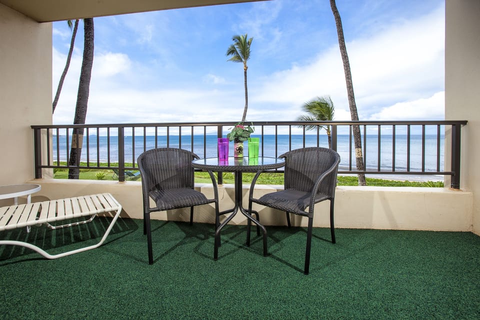Your private balcony offers breathtaking oceanfront views framed by swaying palms, where you can savor morning coffee or evening sunsets with the sound of gentle waves below.