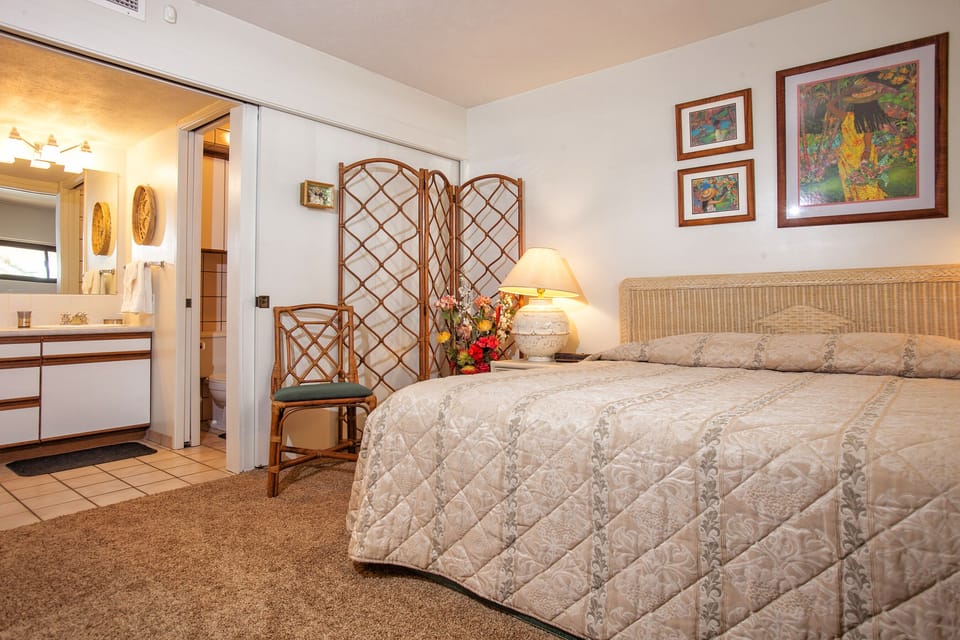 Sink into the plush bed after a restful day, with your private en-suite bathroom just steps away and island-inspired decor creating a peaceful retreat.