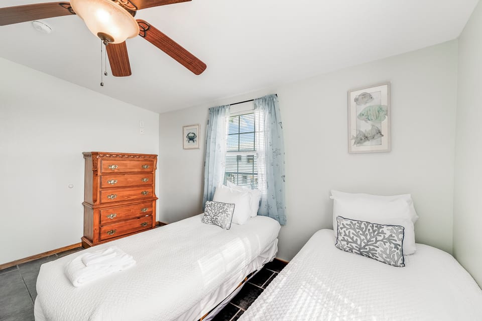 Rest peacefully in your comfortable twin beds under charming exposed beams, with gentle natural light and coastal-inspired decor.