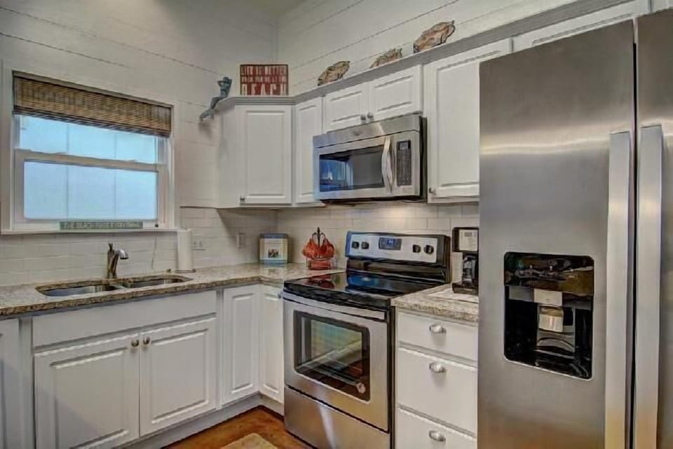 Cook your favorite meals in this fully equipped kitchen with granite counters, stainless appliances, and everything you need to feel at home.