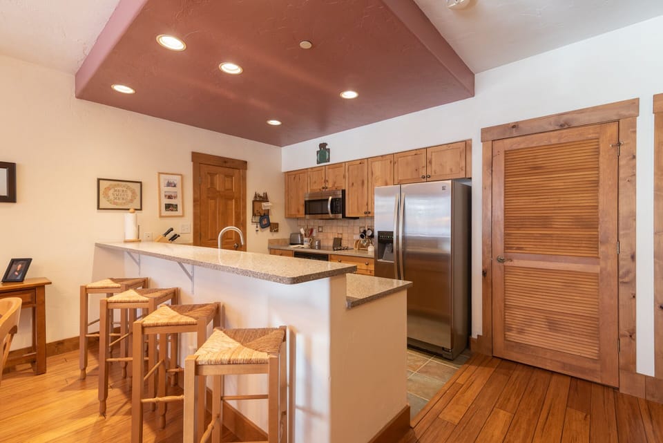 Your spacious kitchen features granite counters, stainless appliances, and bar seating perfect for morning coffee or casual meals together.