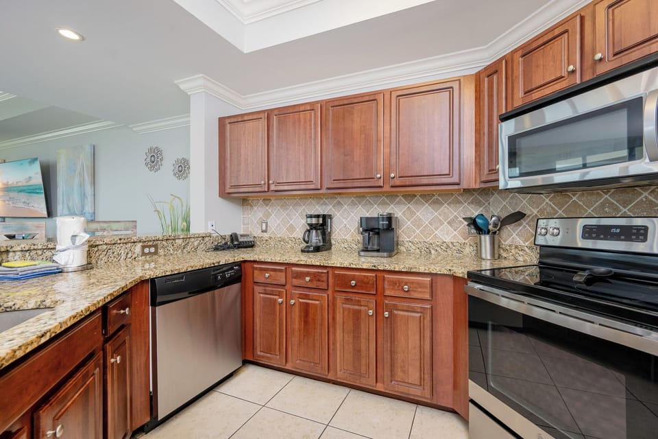 Enjoy a modern kitchen with granite countertops, stainless appliances, and coffee station for a delightful cooking experience