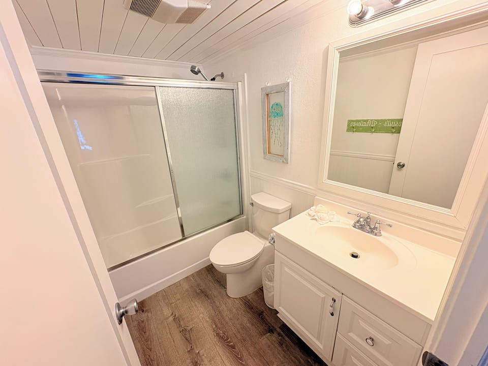 Your private bathroom features a spacious shower-tub combo and vanity with ample counter space for all your essentials.