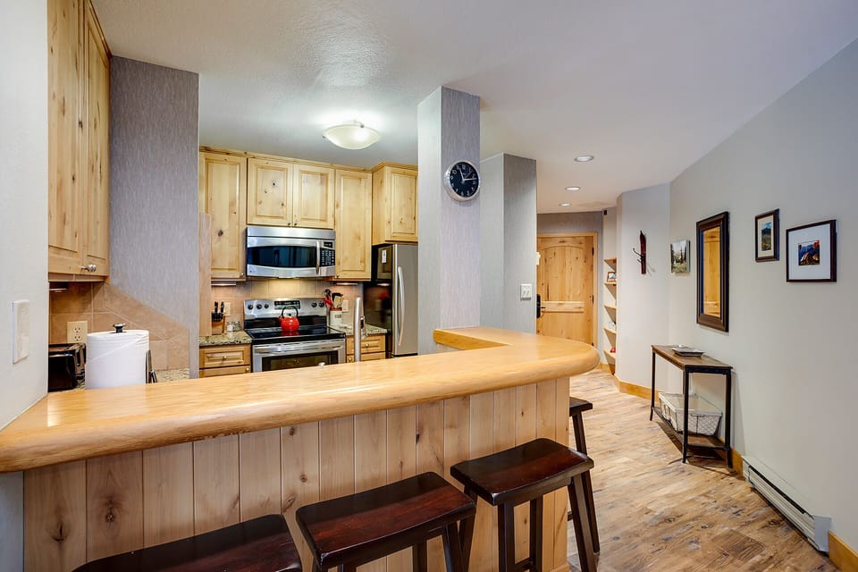 Your open kitchen invites culinary adventures with granite counters, breakfast bar seating, and modern appliances.