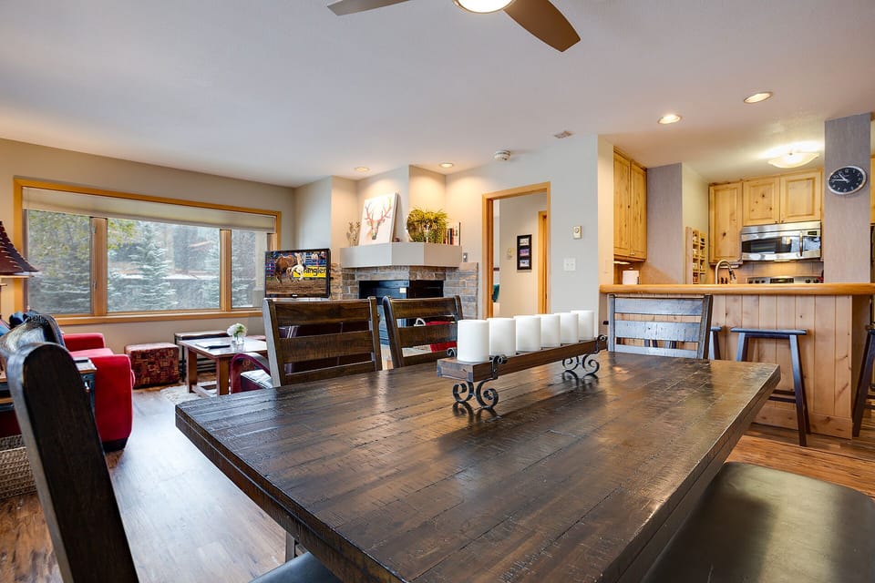 Gather around your spacious dining table with mountain views streaming through large windows, perfect for memorable meals together.
