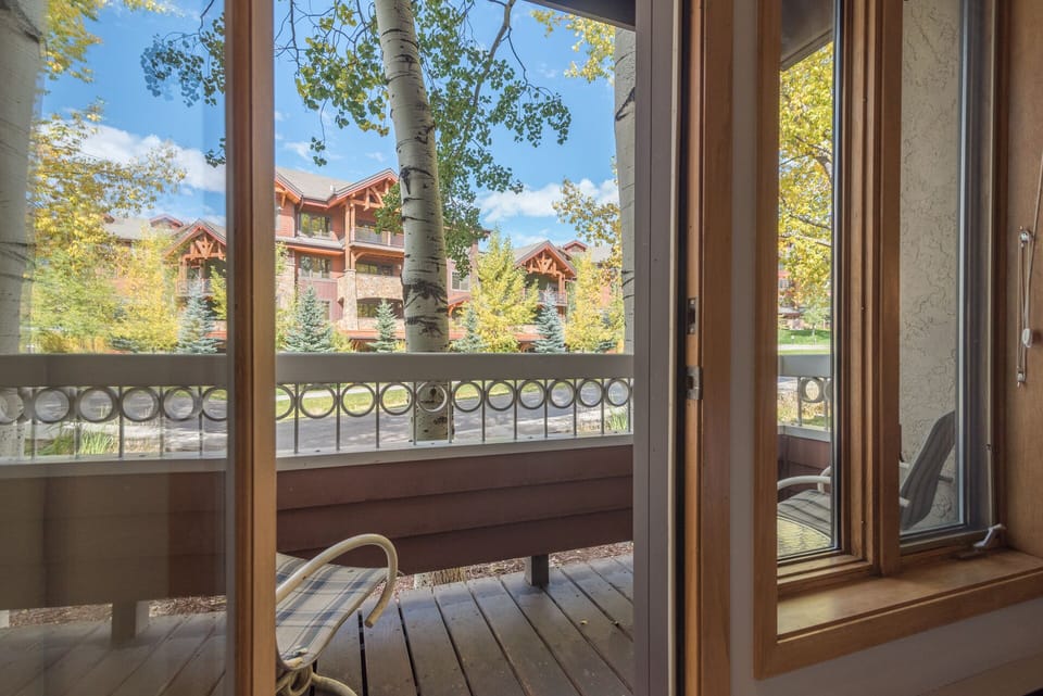 Step out to your private balcony and soak in charming alpine village views through towering aspens.