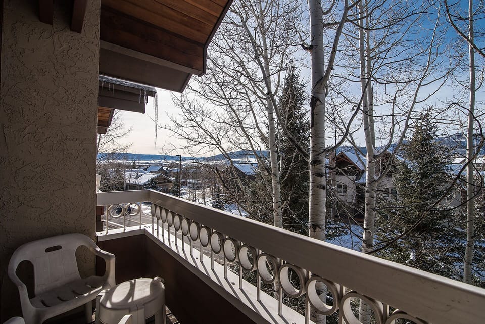Step onto your private balcony and breathe in the crisp mountain air while enjoying peaceful winter views through the trees.