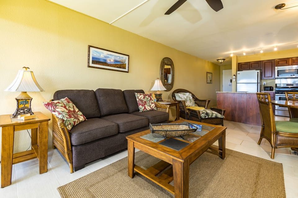 Relax in your bright, open living space with comfy seating, tropical accents, and a fully equipped kitchen just steps away—perfect for unwinding after exploring nearby beaches.