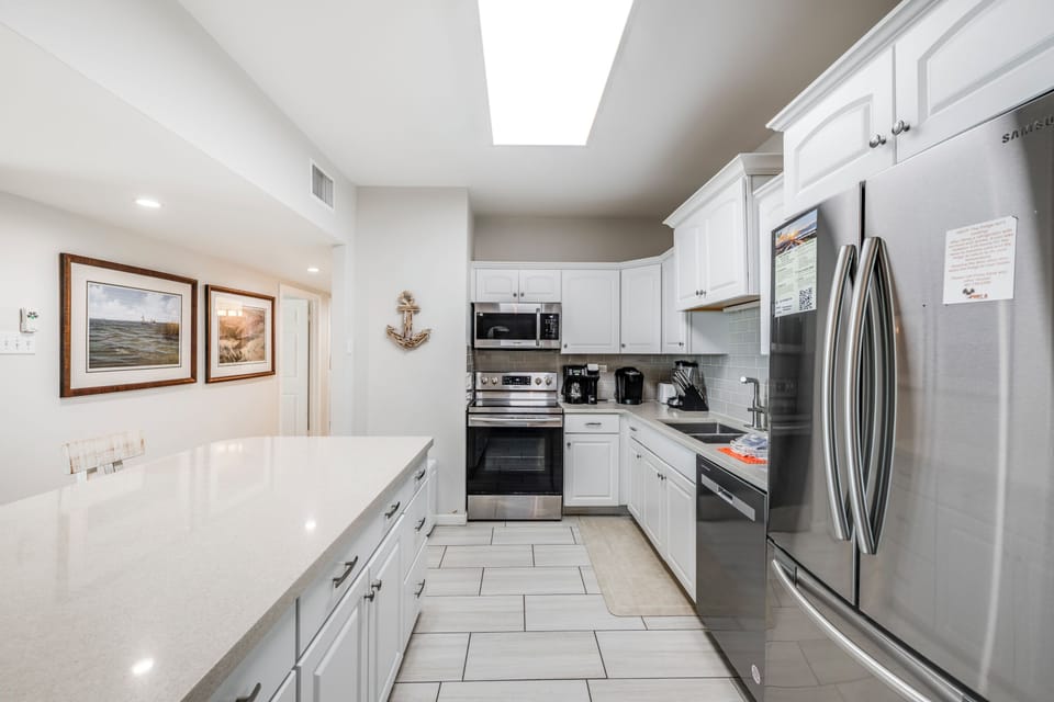 Your bright, fully equipped kitchen features stainless steel appliances and gleaming countertops, perfect for preparing your favorite meals during your stay.