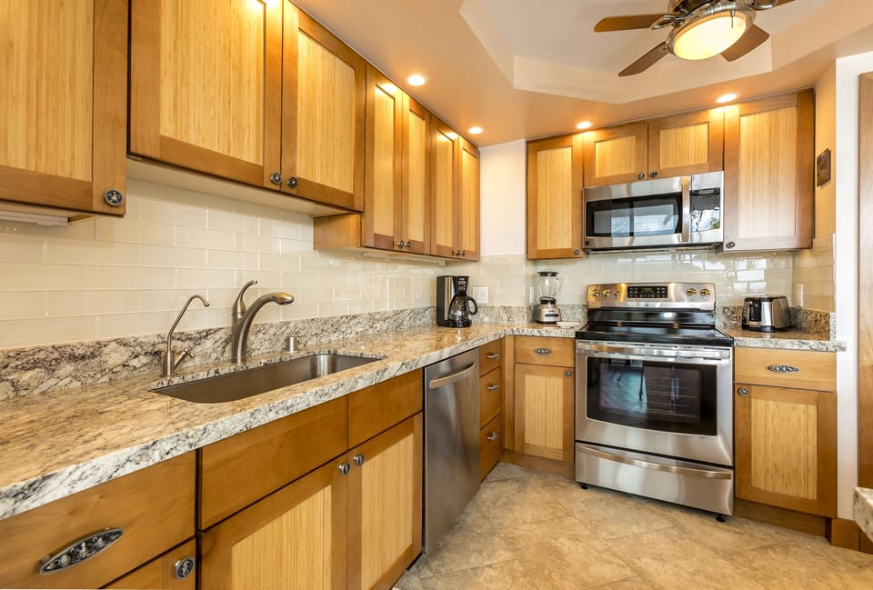 Your fully equipped kitchen features granite countertops, stainless steel appliances, and warm wood cabinetry—everything you need to prepare your favorite meals in comfort and style.