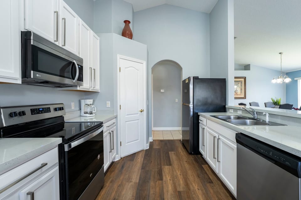 Galley style kitchen showing appliances and pantry