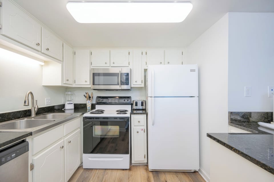 This kitchen features sleek appliances, ample counter space, and a welcoming atmosphere perfect for meal preparation