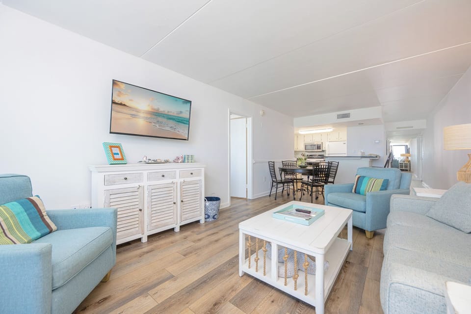 This living area features a comfortable sofa, a stylish coffee table, and a dining space, perfect for relaxation and meals