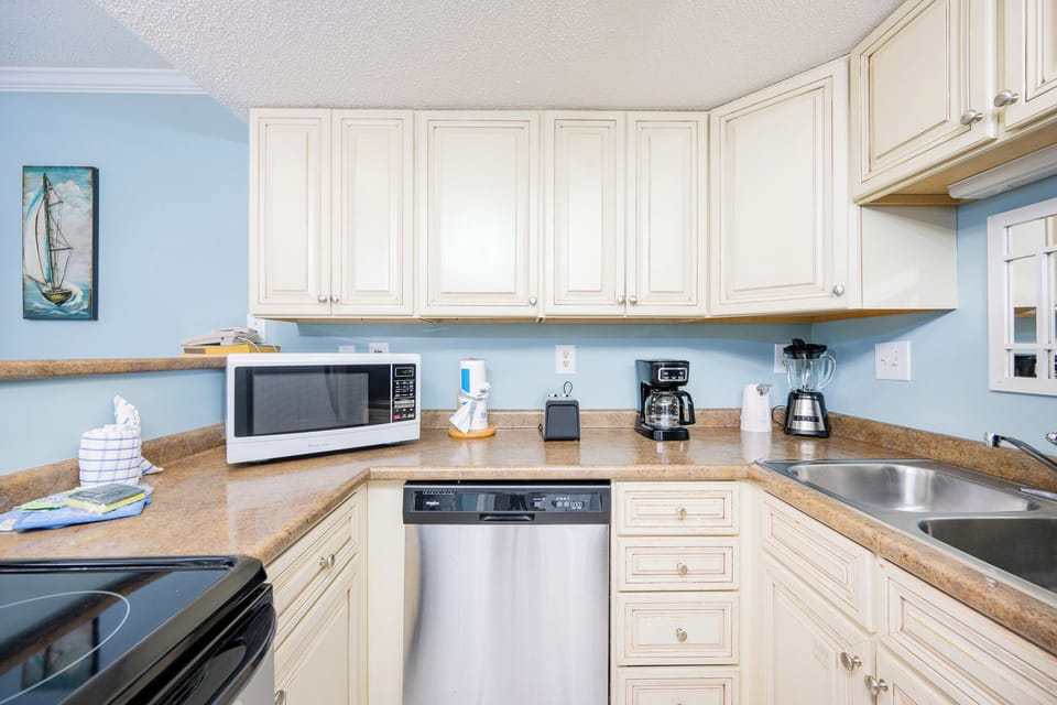 Craft delicious meals and sip morning coffee in this charming kitchen, filled with coastal vibes